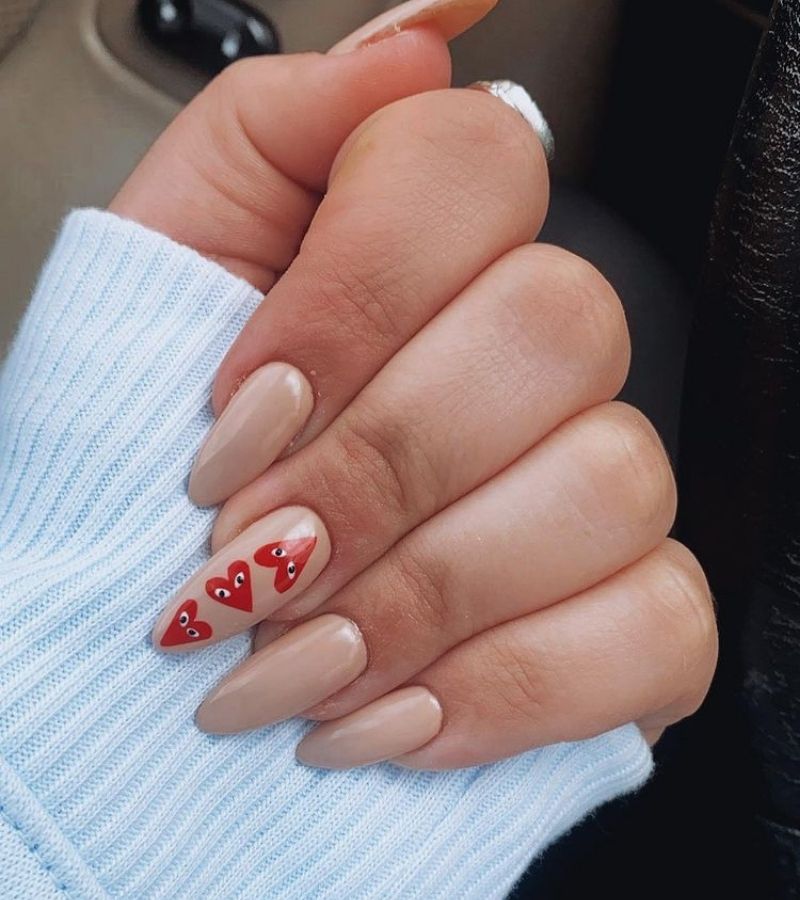 Nude nail polish with a line of red hearts - Heart Nails