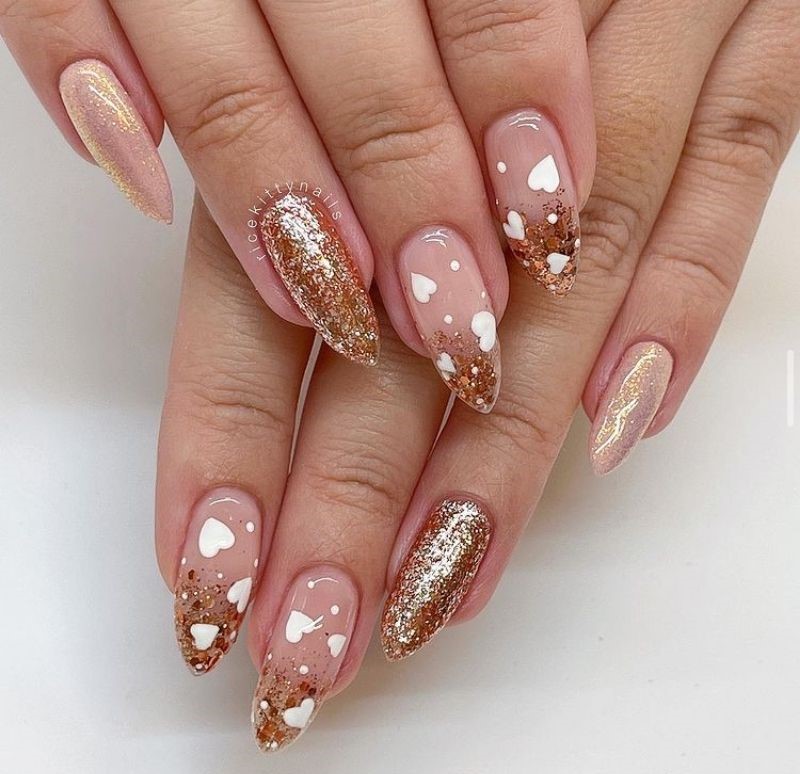 Golden shimmer and white hearts - heart nails