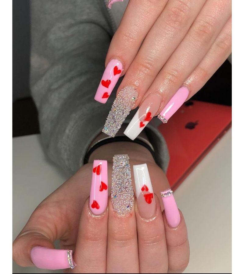 Pink and white base with red hearts - cute valentines nails