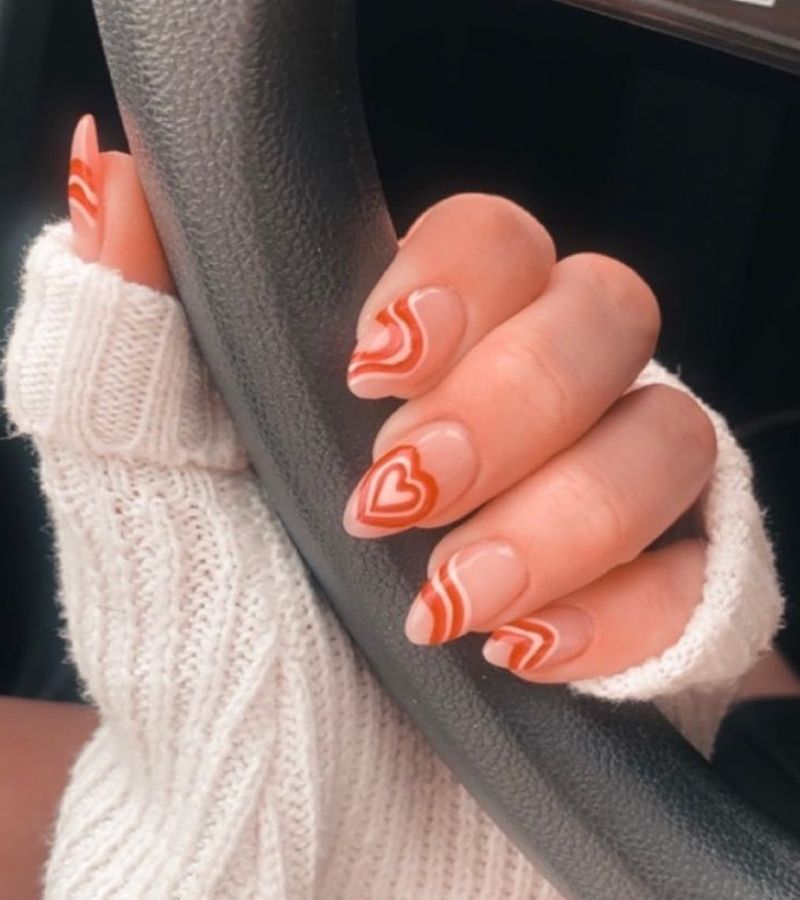 Heart nails with orange color - simple heart nail designs