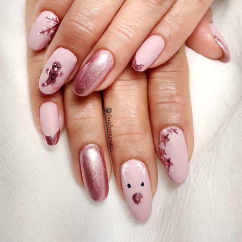 Light pink nails with drawing of Rudolph and gingerbread