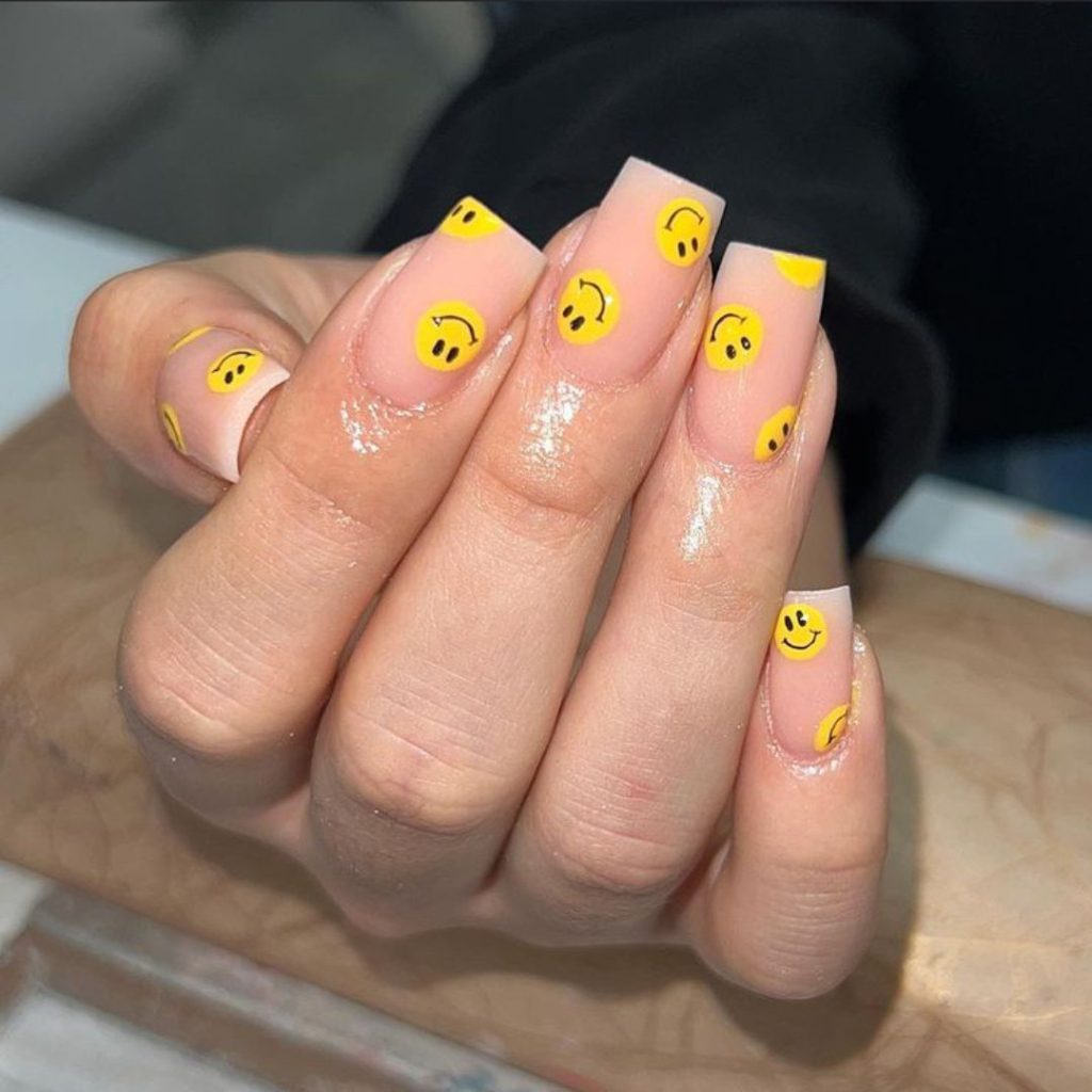 Smiley face on nude nails