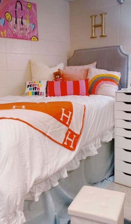 preppy dorm room ideas with hermes orange blanket on xl twin bed and vibrant pillows