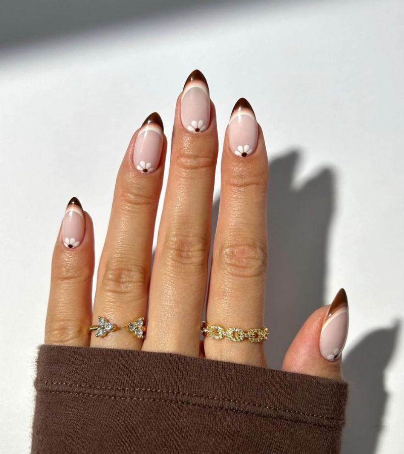 brown tips with white florals on cuticle