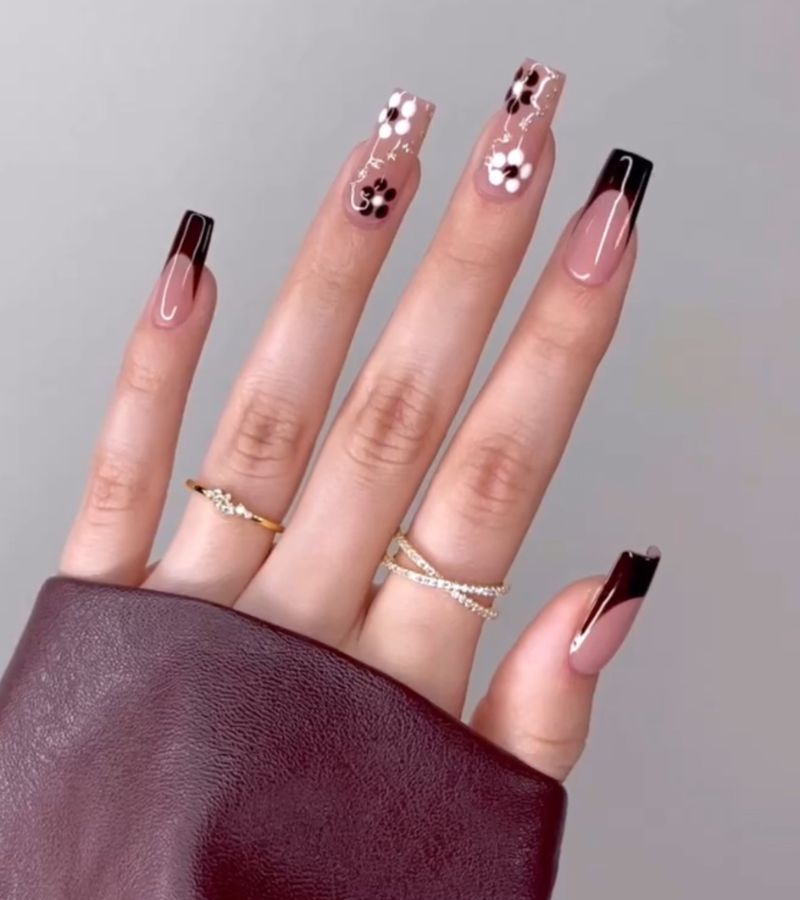 dark chocolate-colored nails with elegant floral patterns