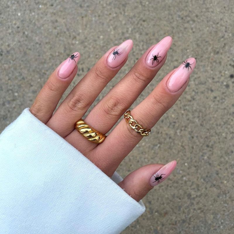 Pink nails with black spiders 