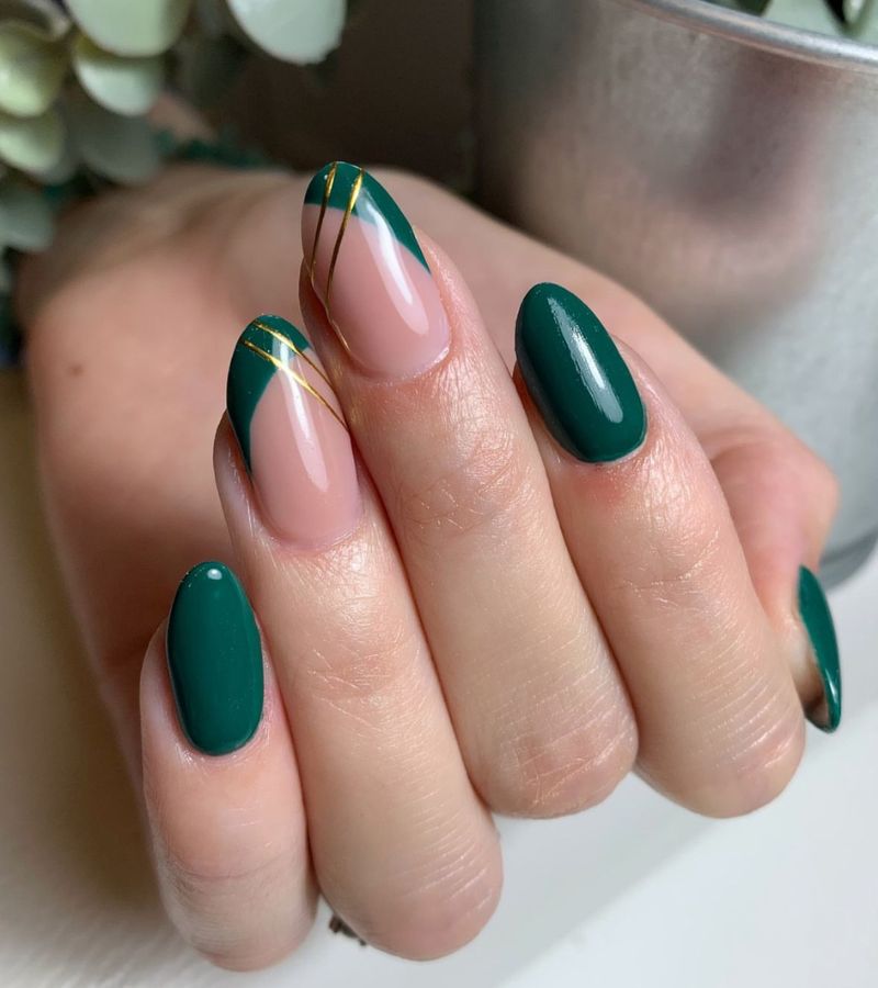 Dark green nails with gold lines 