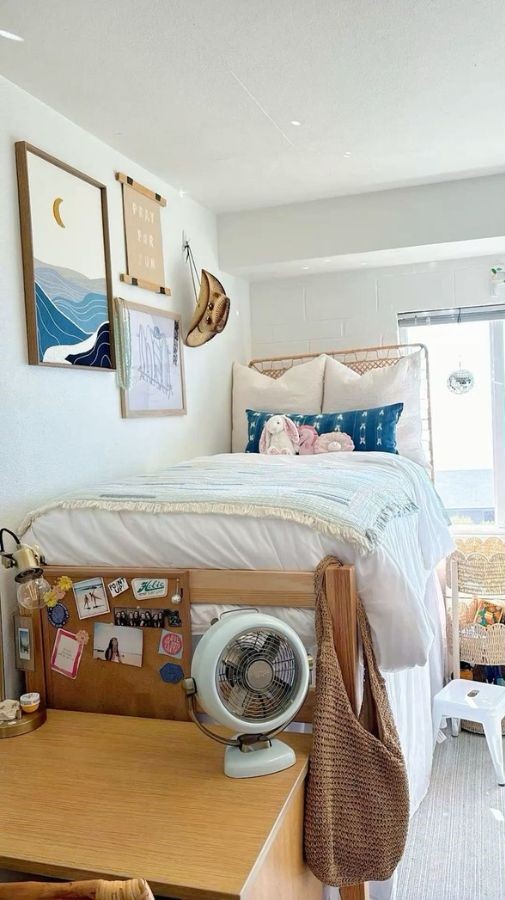 calrm coastal dorm room setup with neutral bedding, soft blankets, and blue and beige beachy tones