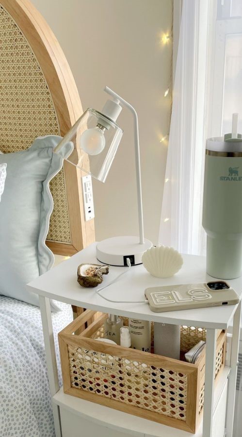 coastal dorm nightstand with rattan tray, shell candle, and natural textures