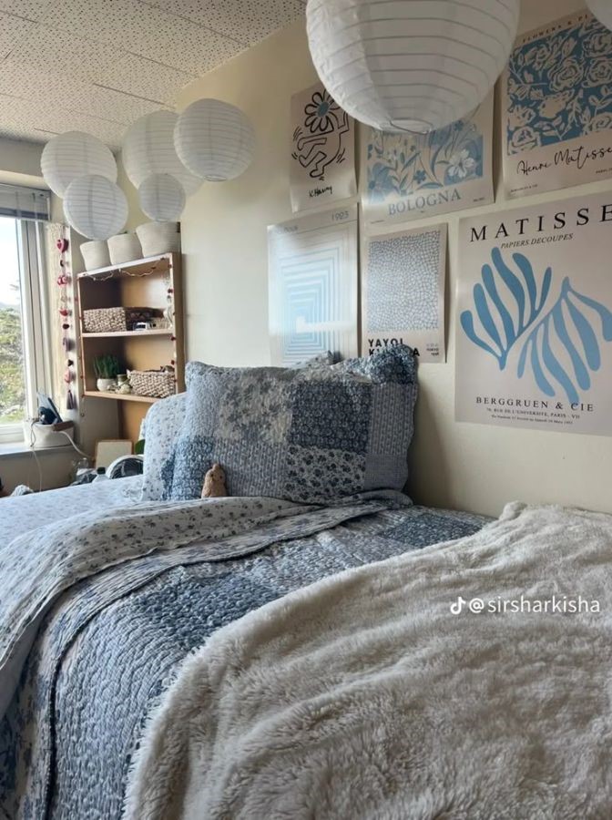coastal dorm room with white hanging lanterns, beach wall art, and soft lightning
