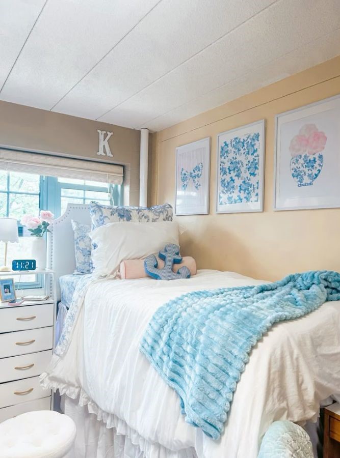 coastal dorm room with floral prints, pillow textures, and blue and white bedding