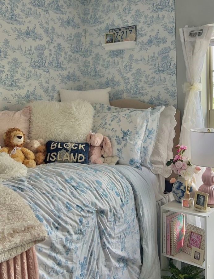 dorm wall with light blue and white striped peel-and-stick wallpaper behind the bed