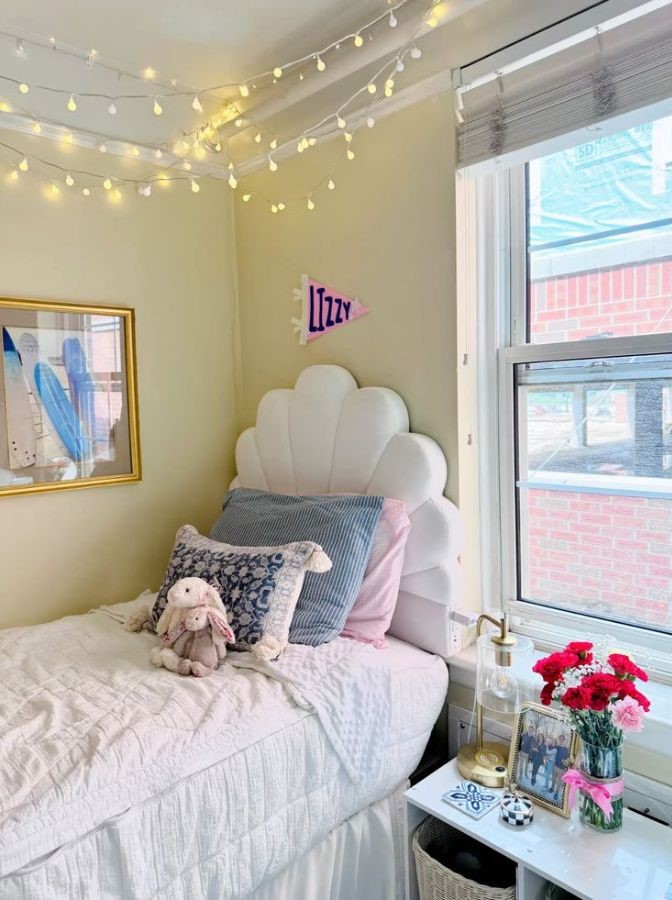 white scalloped headboard shaped like a seashell, styled, with white bedding and colorful coastal dorm decor