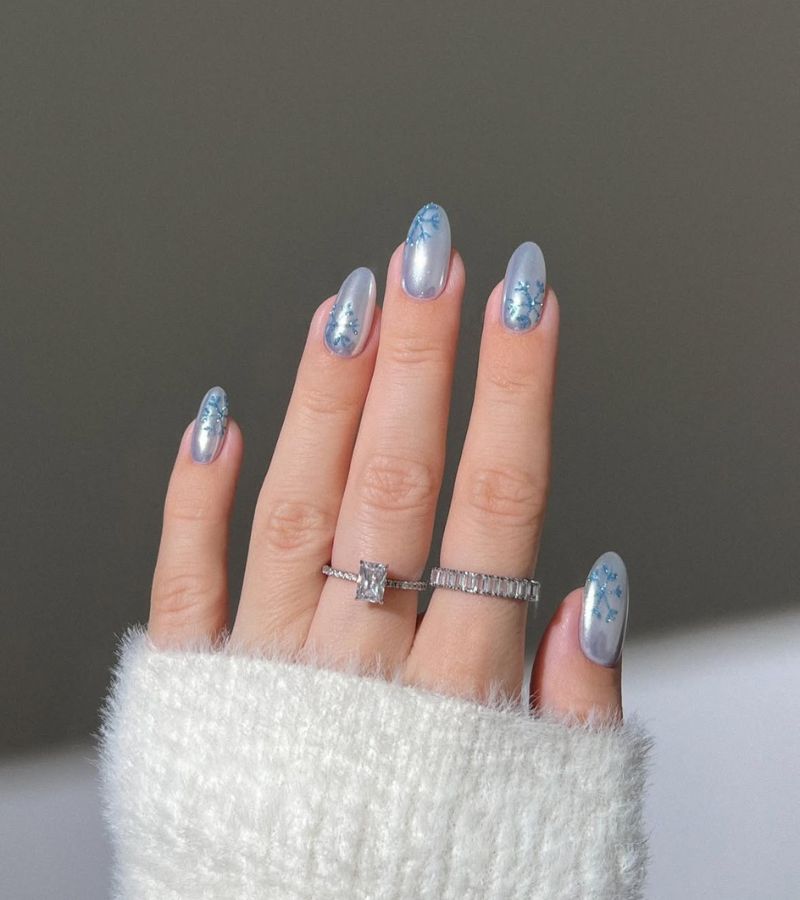 icy blue nails with dark blue snowflake