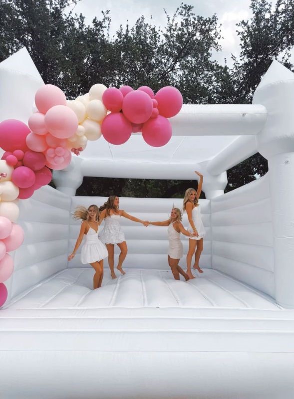 white bounce house backyard graduation party