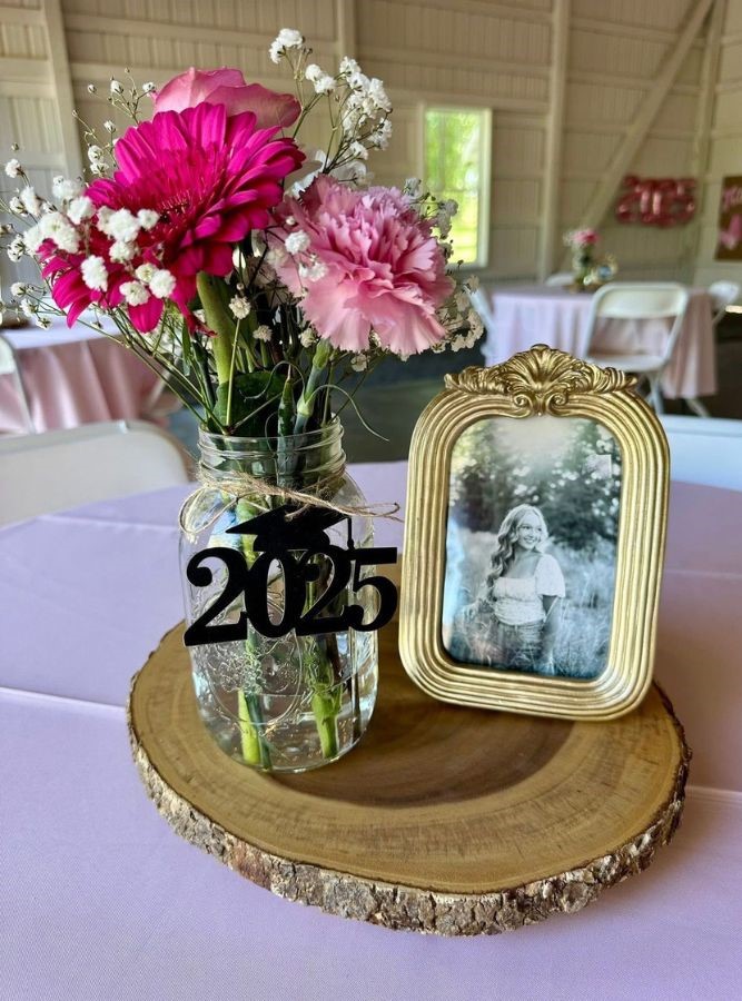 graduation mason jar with flowers and a gold frame of grad