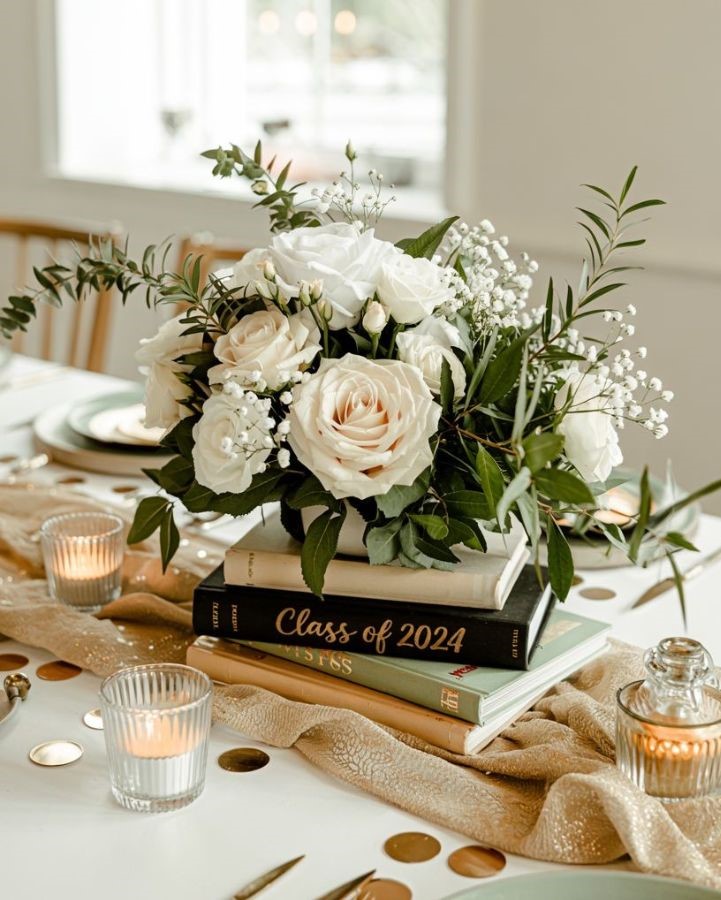 four book stack and a mini flower vase on top