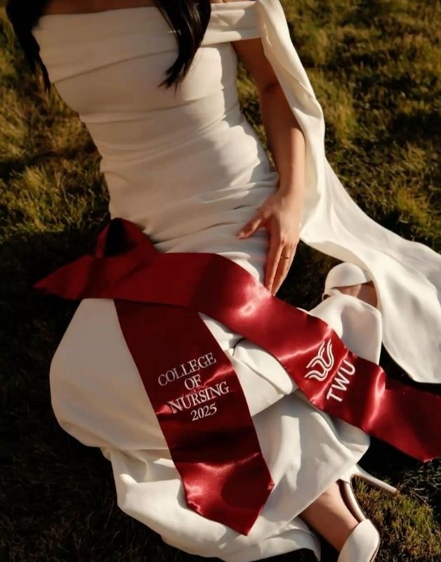 graduation stole detailed shot on the grass with white dress