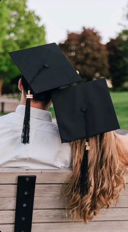 leaning on each other with grad caps