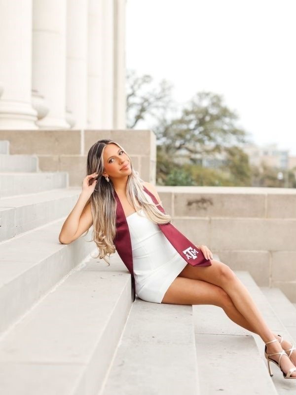 lean back and pose in a white graduation dress - graduation  photoshoot ideas